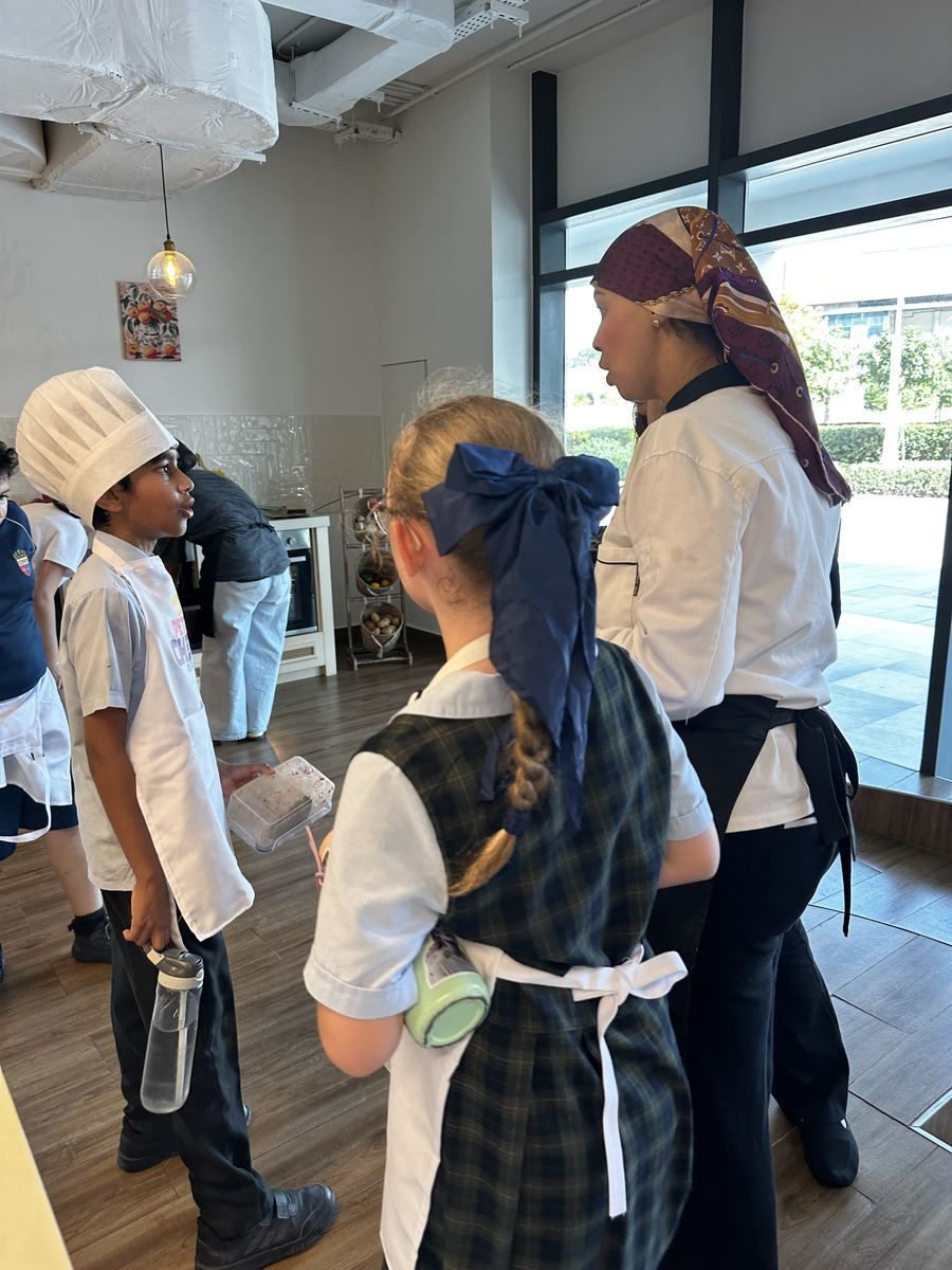 Chef guiding young chefs